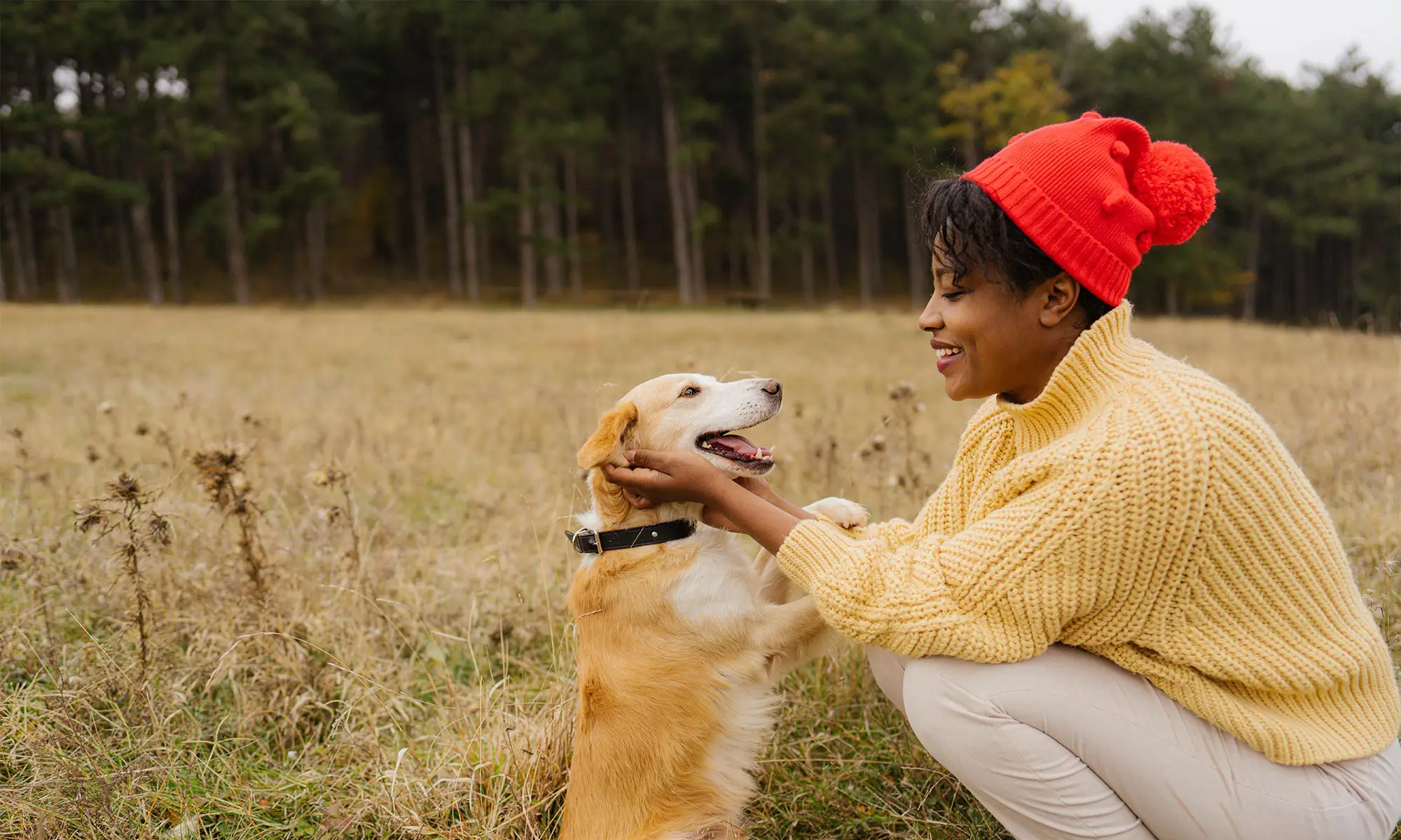A woman outdoors with her dog